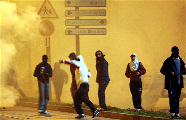 Muslim rioters throw rocks at firefighters and police officers during clashes, Toulouse, southwestern France, November 7, 2005.